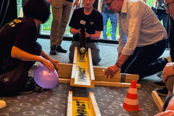 A group of people playing with a marble run
