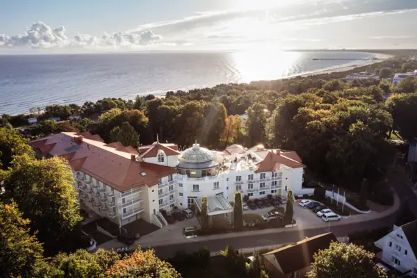 Heringsdorf A large building with trees and a body of water.