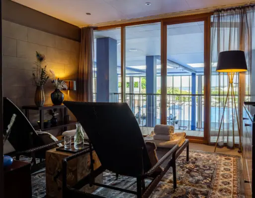 A room with a large glass door and a large terrace.