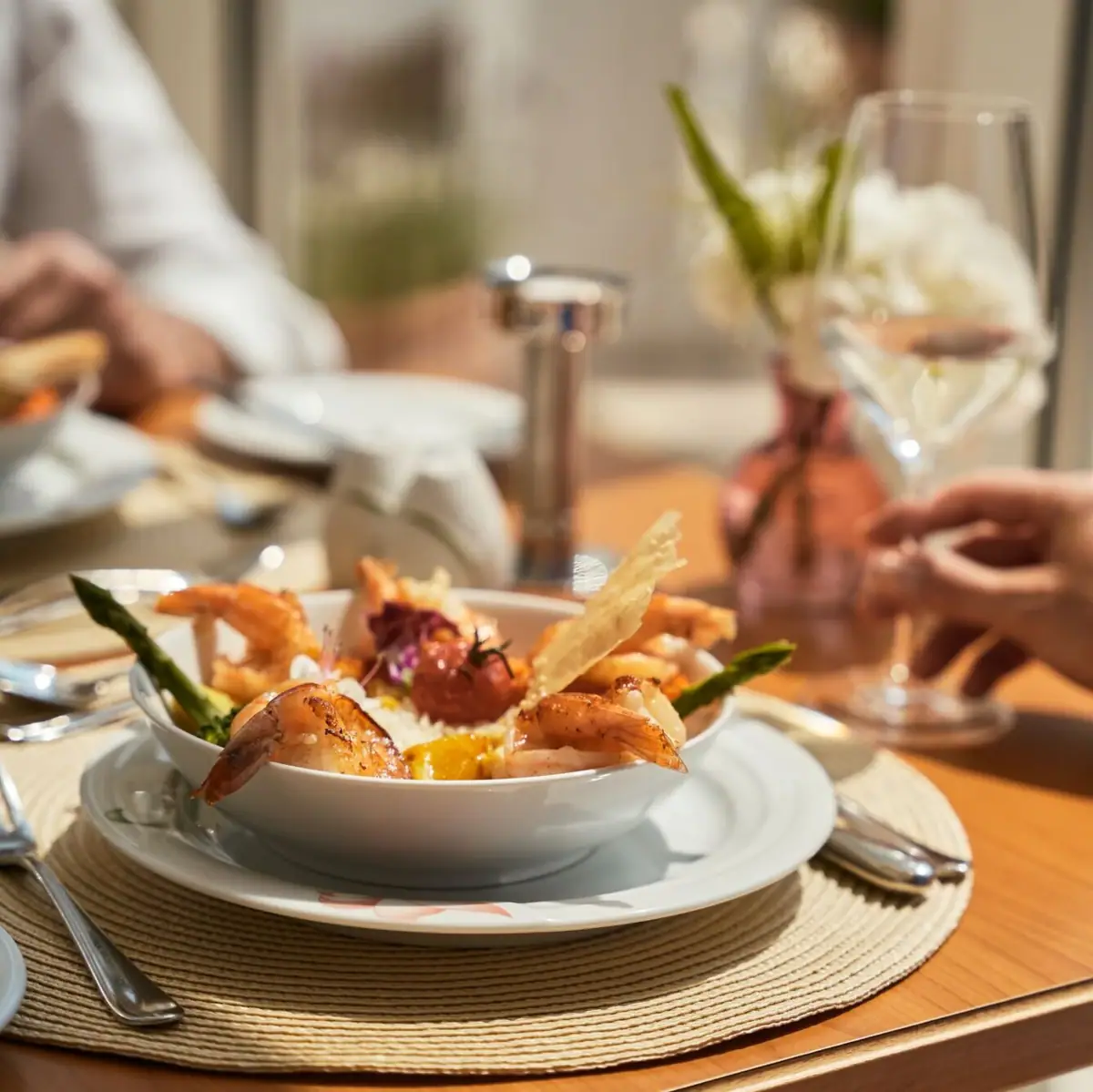 A bowl of shrimp on a plate.