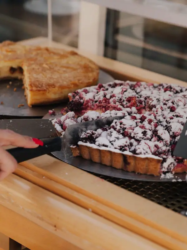 One person cuts a cake.