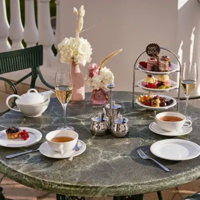 A dining table set with various dishes and drinks.