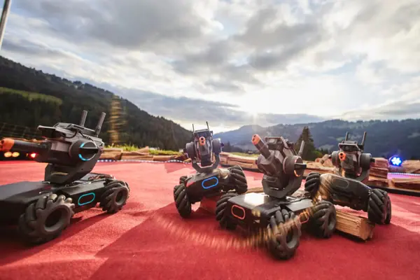 A group of robots on a red surface.