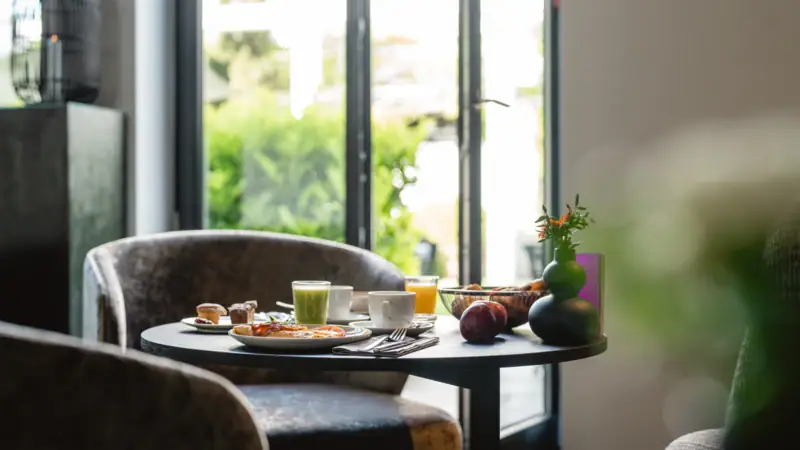 Breakfast table set with food and drinks.