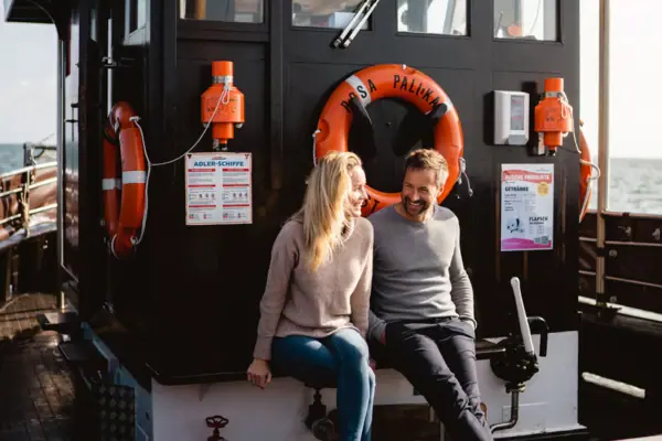 A man and a woman are sitting in a boat.