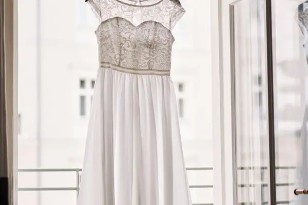 A white dress on a swinger, showcasing fashion design and embellishment.