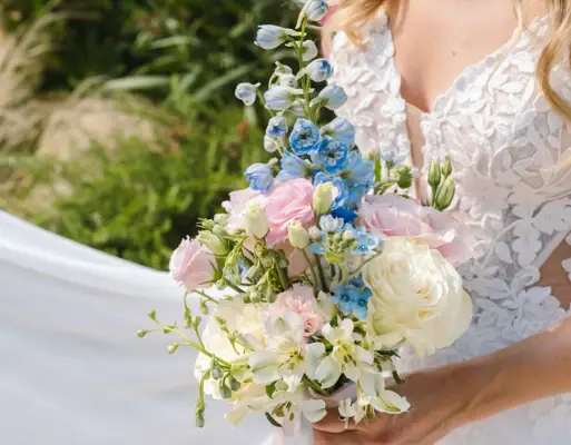 Bridal bouquet A woman in a white wedding dress is holding a bouquet of flowers.