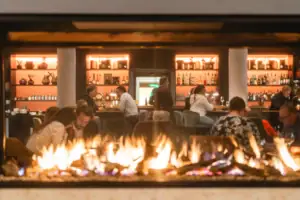 A group of people are sitting at a bar.
