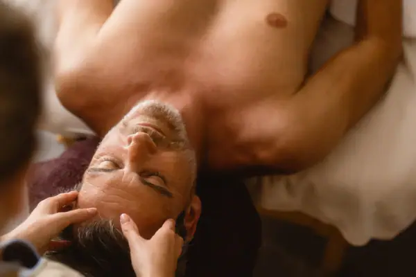 Balance Ritual The man is lying on his back for a facial massage.