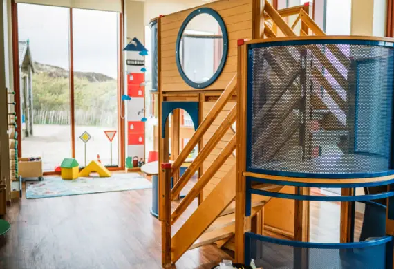 Play area with play structure in an interior space.