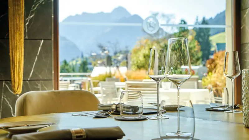 Kilian Stuba Restaurant A table set with wine glasses and cutlery.