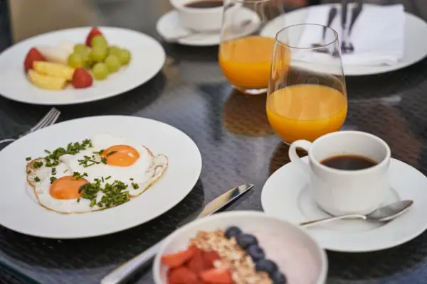 A table with plates full of food and drinks.