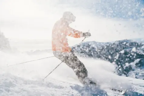 Person skiing in deep snow.