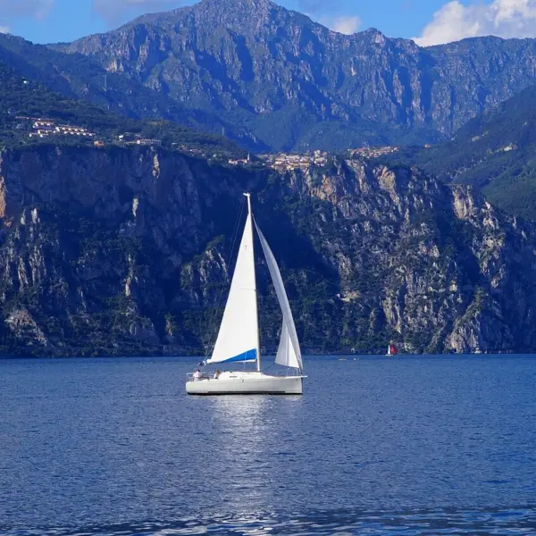 Sailboat on the water with mountains in the background.