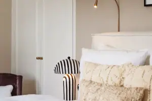 A bed with pillows and a lamp.