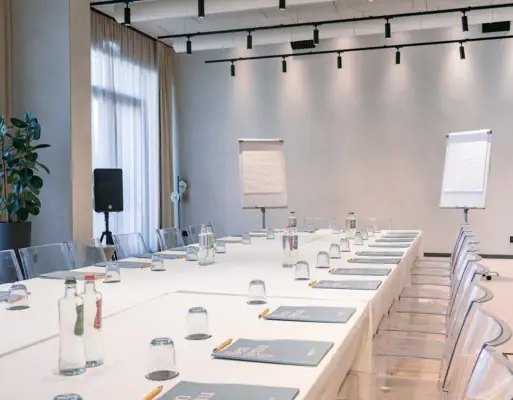 Conference room with white tables and chairs.