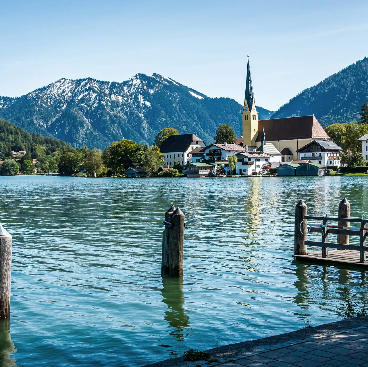 Lake Tegernsee, with a church and mountains in the background.