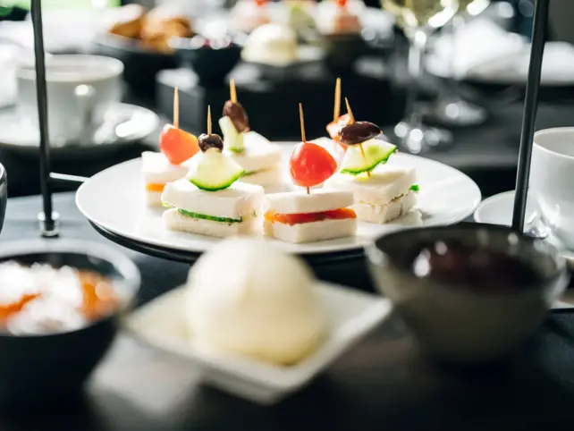 An etagere plate with small appetizers on skewers. 