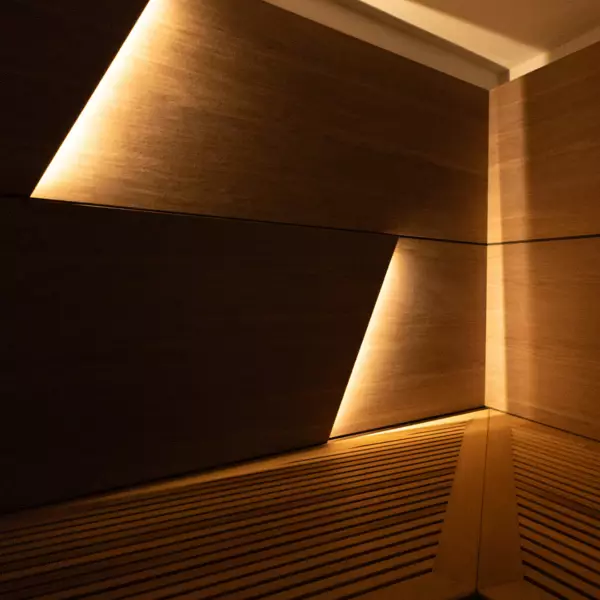 A close-up of part of his wooden sauna, which is illuminated by warm light