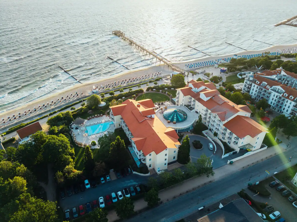 Aerial view of a resort featuring a pool and a pier.