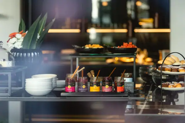 Jars of jam and bowls on a table.