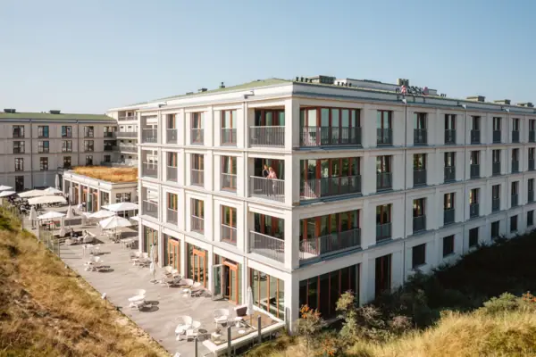 A building with lots of windows and a terrace.