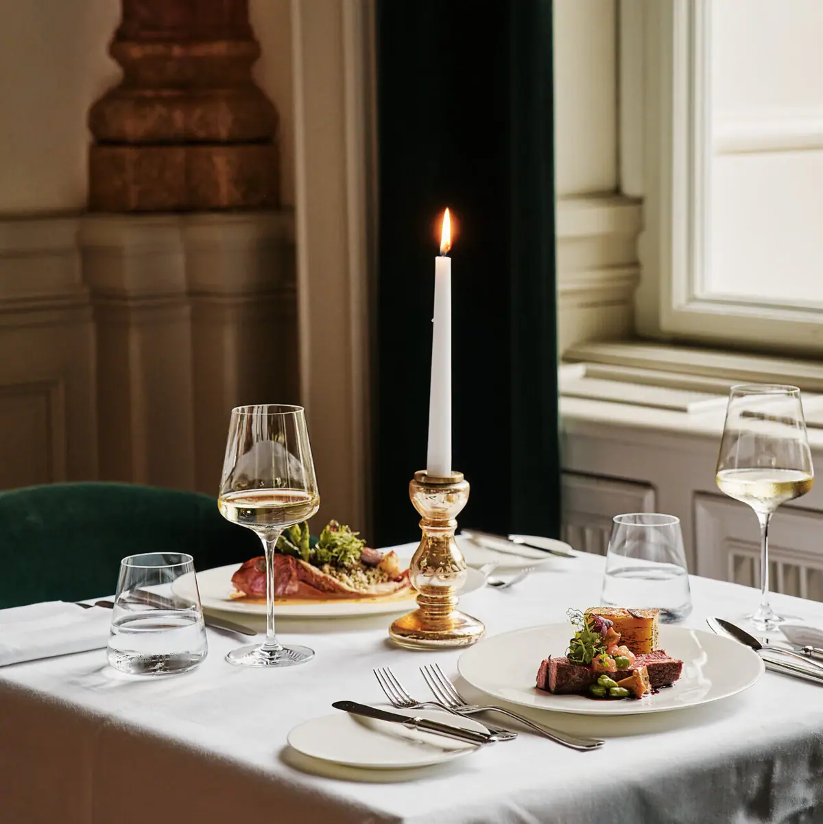 A table laid with plates and food.