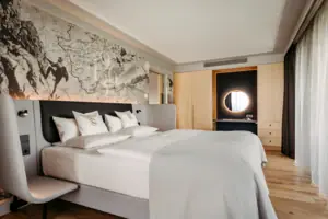 A bed with a map on the wall.