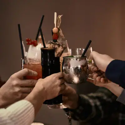 Events A group of people holding up drinks indoors.