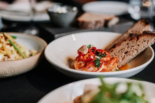 Plate of food on a table, including main course and garnish.