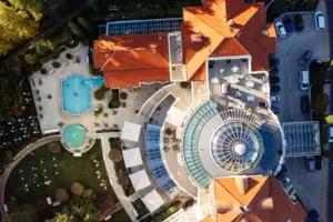 Aerial view of a building with two pools