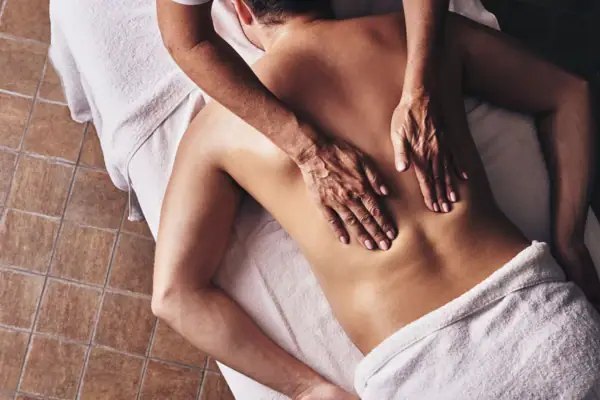 A person receiving a back massage.