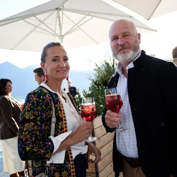 A man and a woman are holding wine glasses.