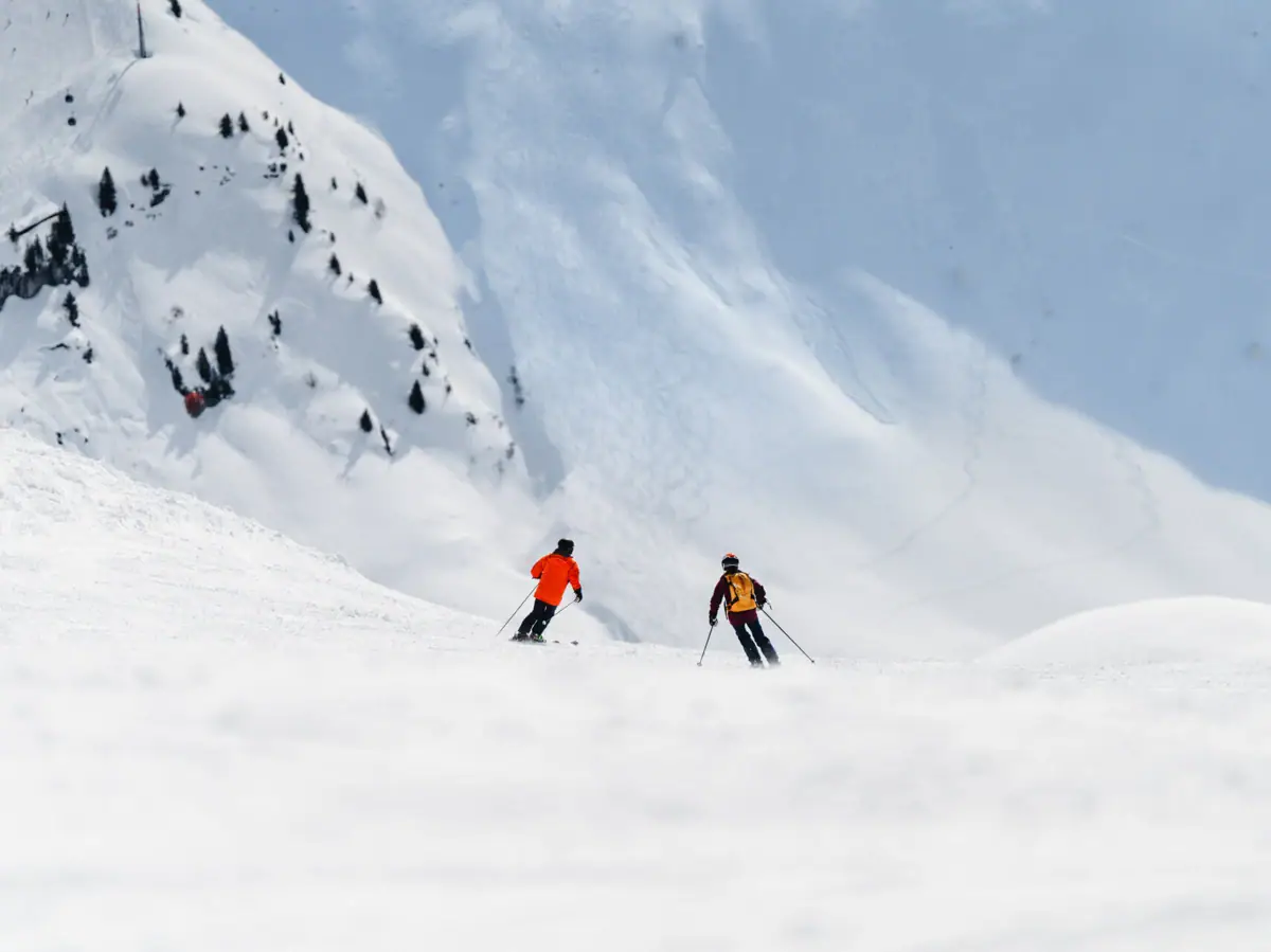 A group of people are skiing down a snow-covered mountain.