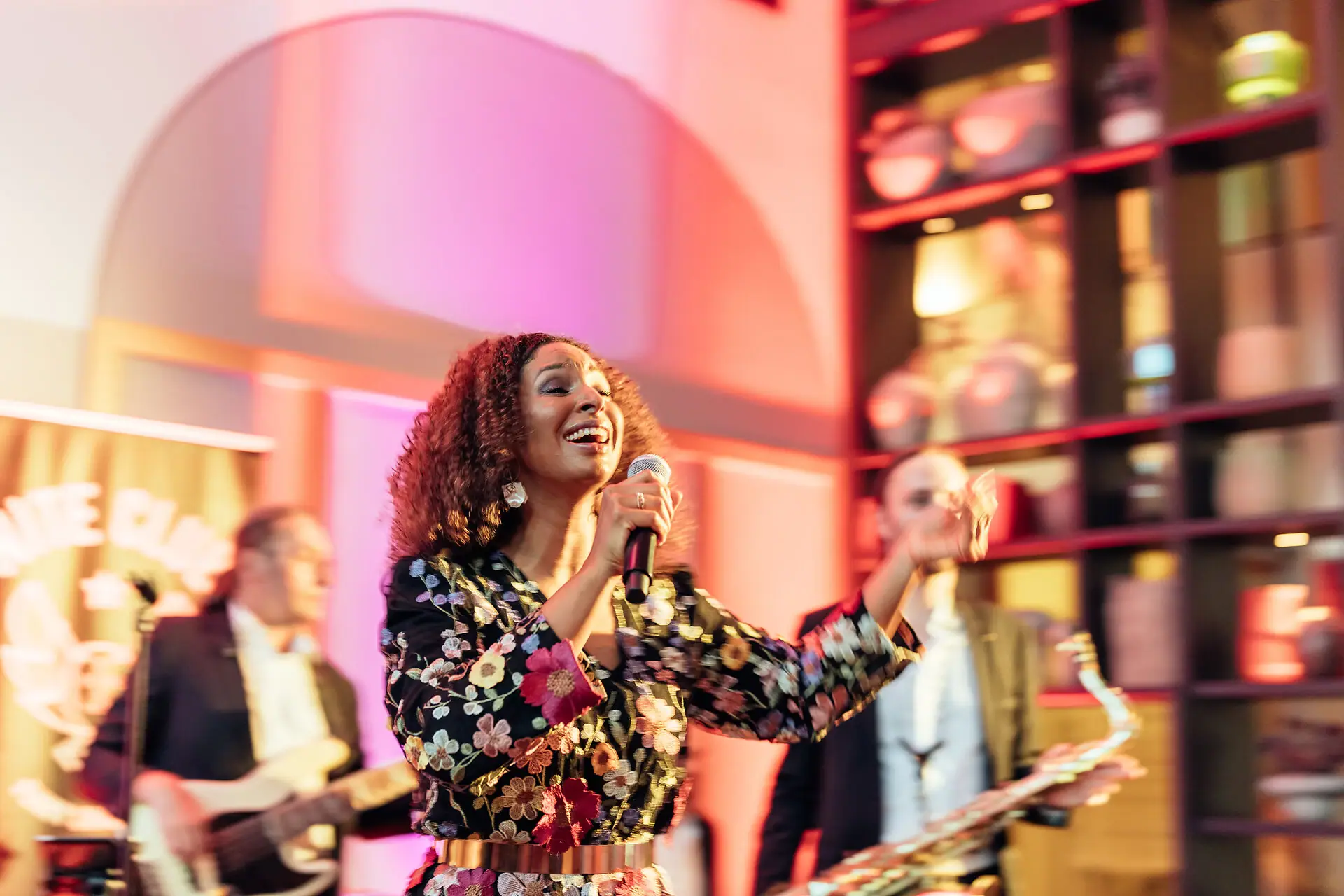 A woman is singing into a microphone.