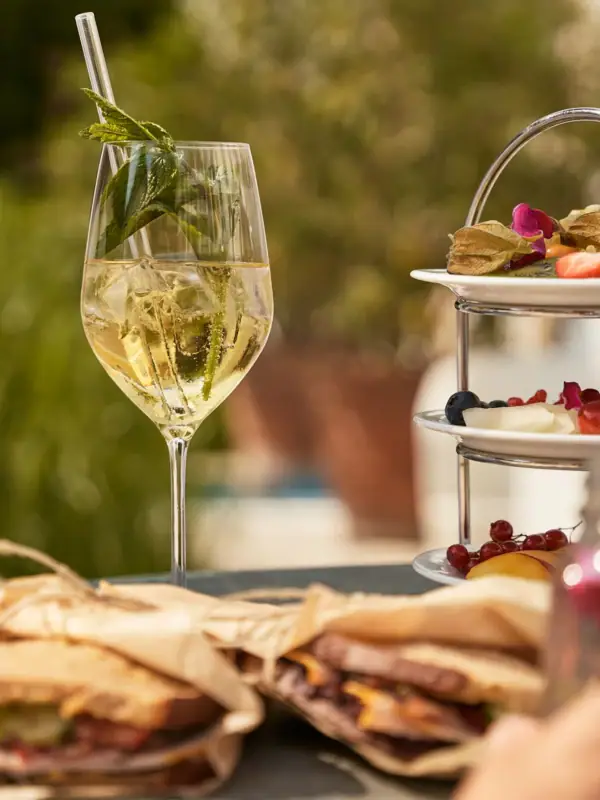 A plate of food with a wine glass on a table.
