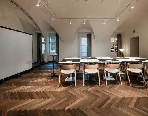 A room with a table and chairs, featuring indoor furniture and interior design elements.