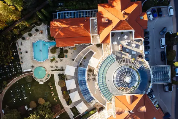 Aerial view of a building with two pools