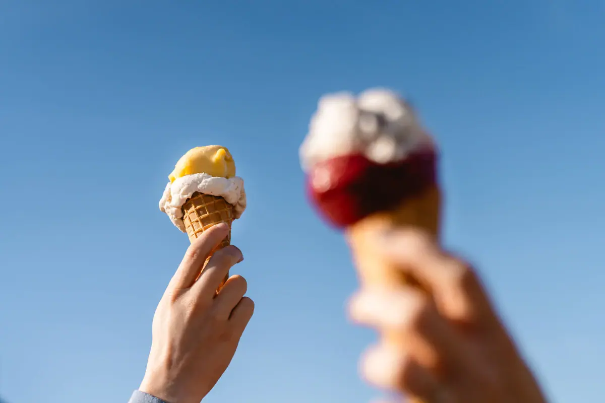 Sylt Ice Cream Factory Two hands are holding two ice-cream cones.