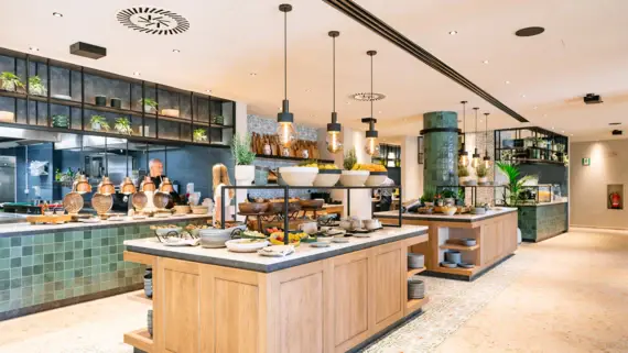 Buffet in a restaurant with various dishes on a counter.