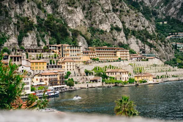Limone sul Garda A town on the shore of a lake, with mountains in the background.