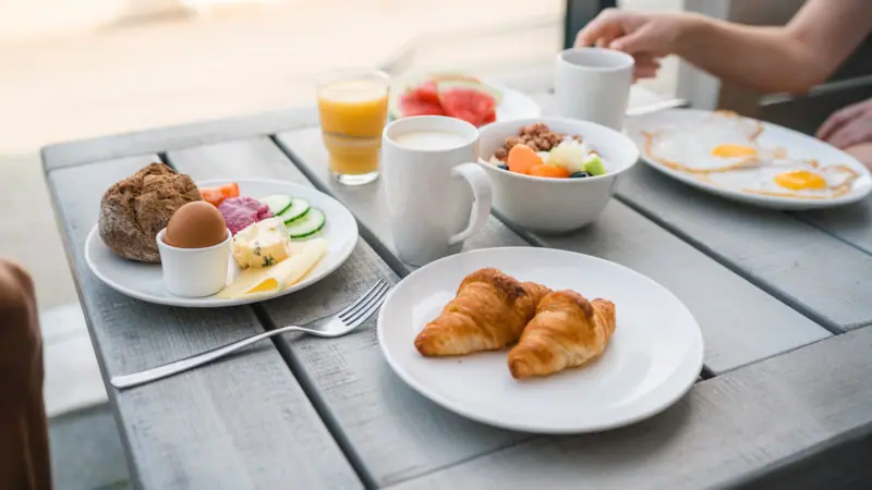 Breakfast A table with various dishes and crockery.