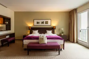 Bedroom with bed and bench.