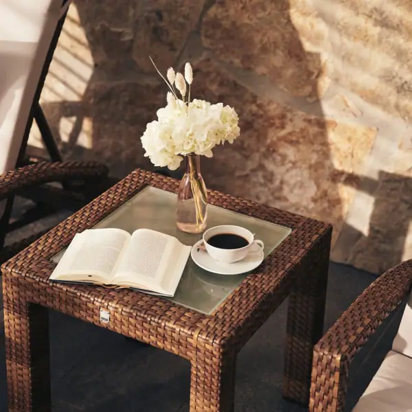 Coffee cup and book on a table.
