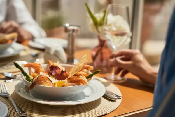 A bowl of shrimp on a plate.
