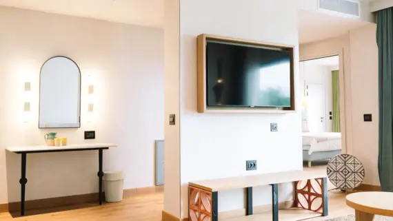 TV mounted on a wall in a modernly designed room.