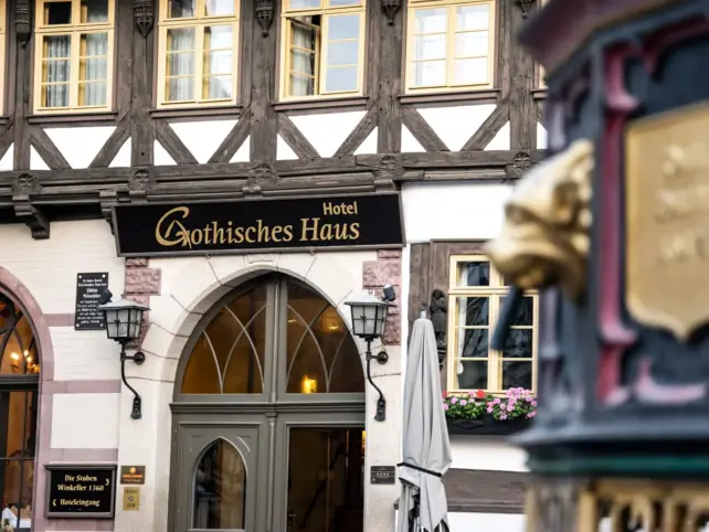 Building with a sign on it, surrounded by windows and a door.