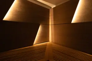 Sauna A room with wooden walls and lighting.