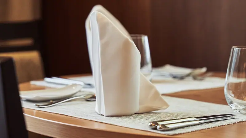 A table with a napkin and glasses.