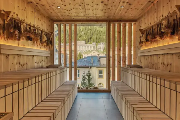 A room with wooden benches and a large window.